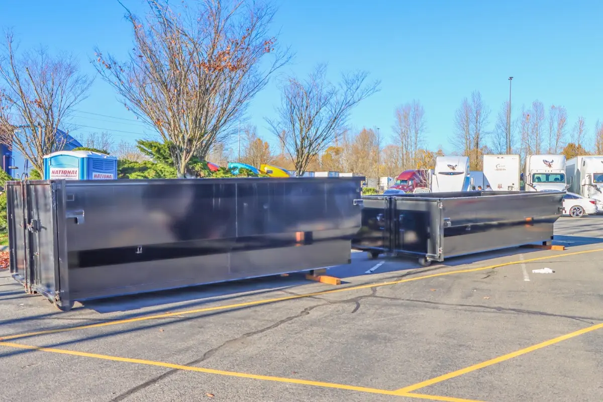 Professional dumpster rental service with roll-off container on residential driveway in Broadlands